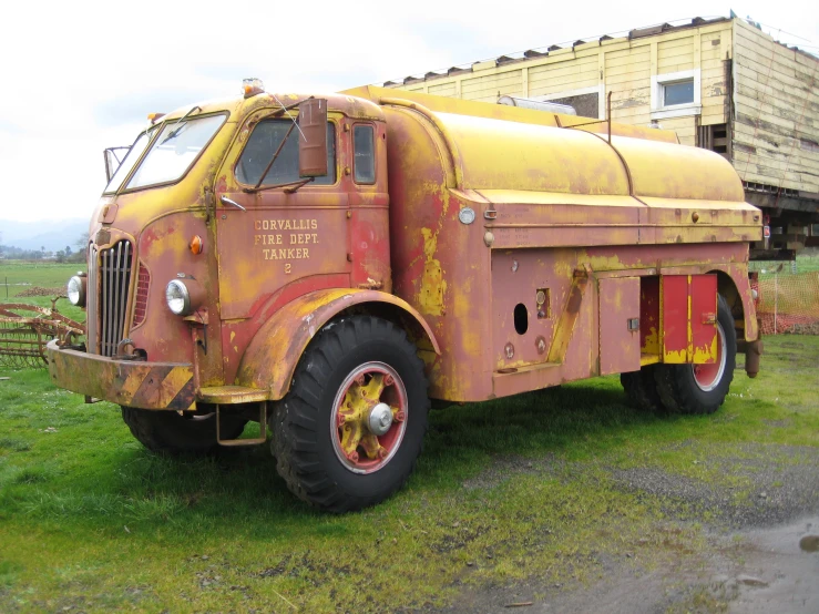 an old delivery truck is parked outside of the building