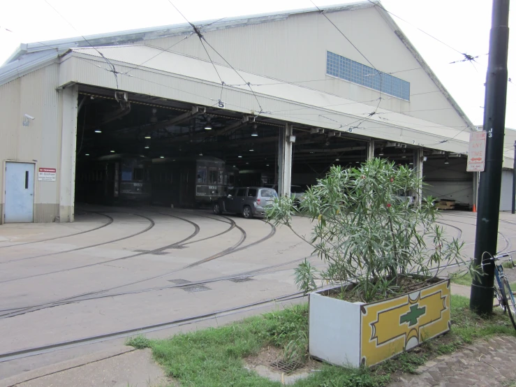 an abandoned factory has grass and a truck in it