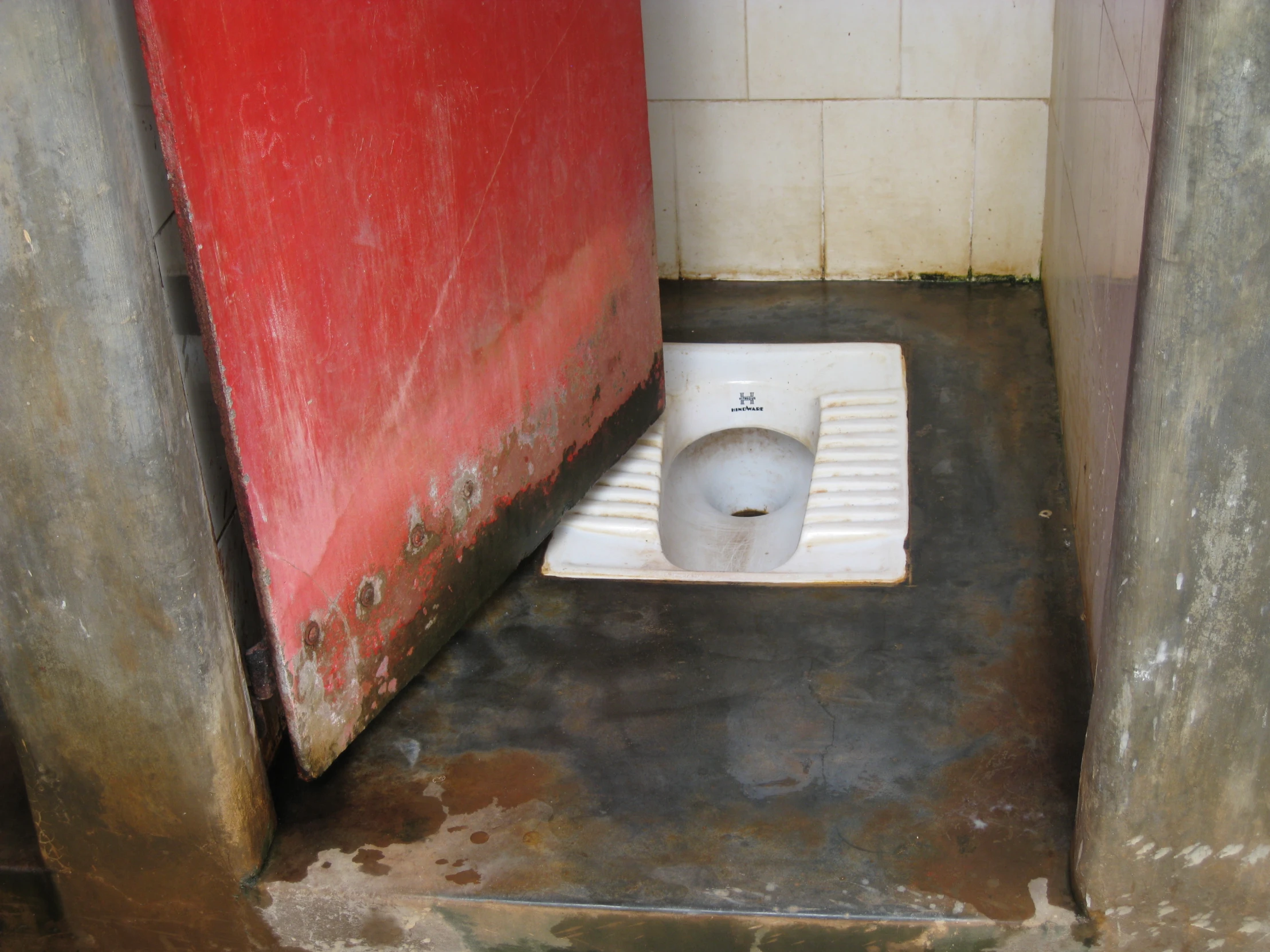 a toilet in an old  cell stall