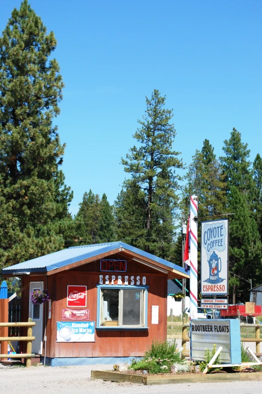 a business on the roadside with lots of trees in the background