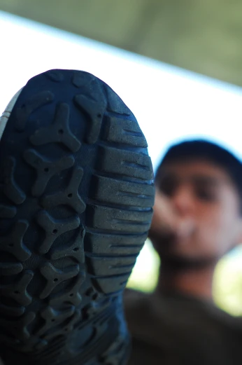 a man is looking at the sole of a shoe