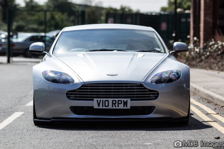 a silver sports car parked on the side of a road