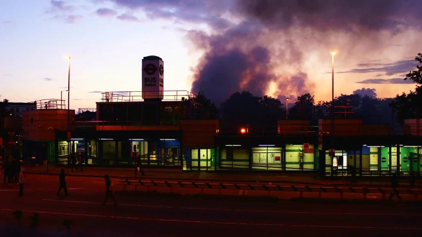 fire is going up behind a gas station on the street