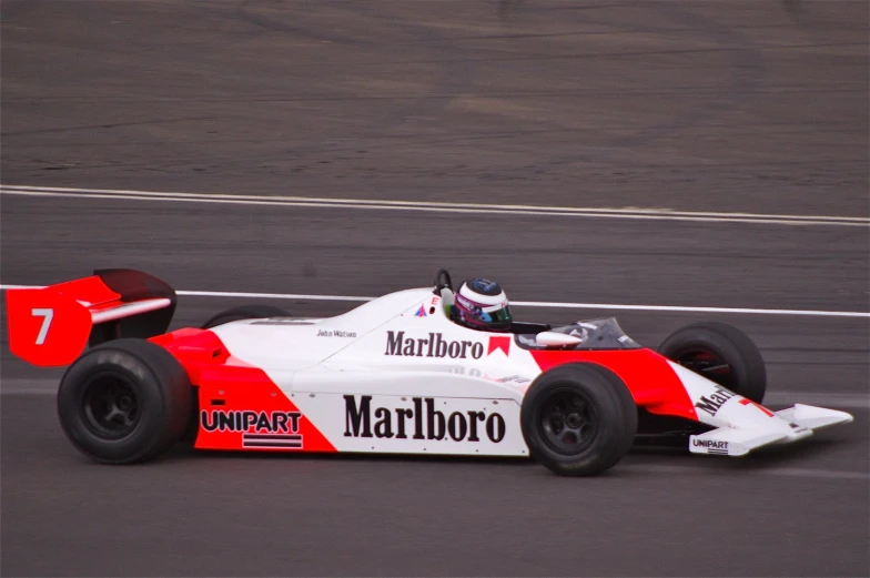 a man drives a racing car down a track