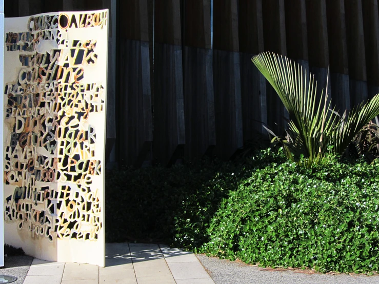 an open paneled door is shown in front of a tree