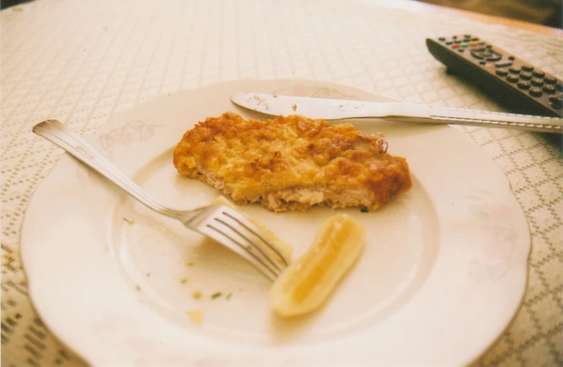 a fork and knife sit on a plate that has a piece of bread on it