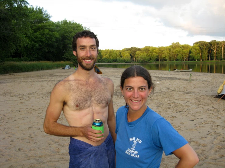 a couple on the beach posing for a po