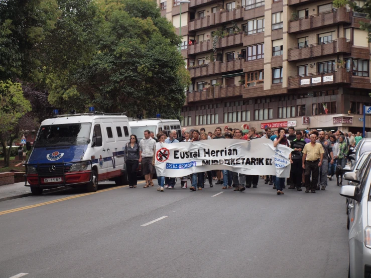 group of people with banners in street in urban setting