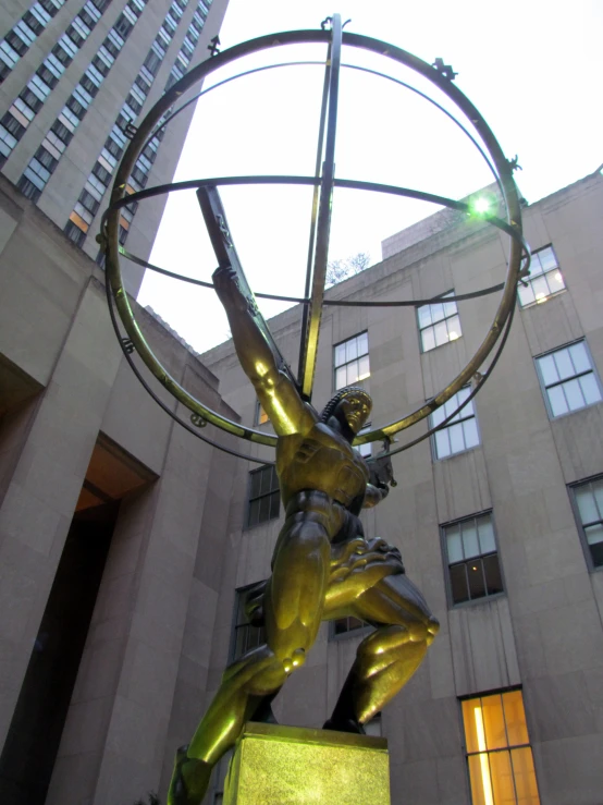 the statue of a woman is posed with a large ring