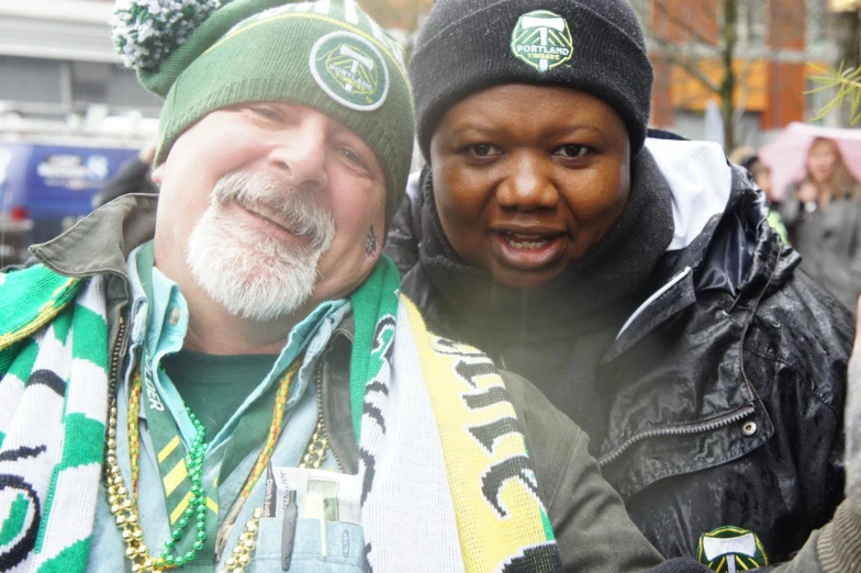 two men are posing for the camera in a stadium