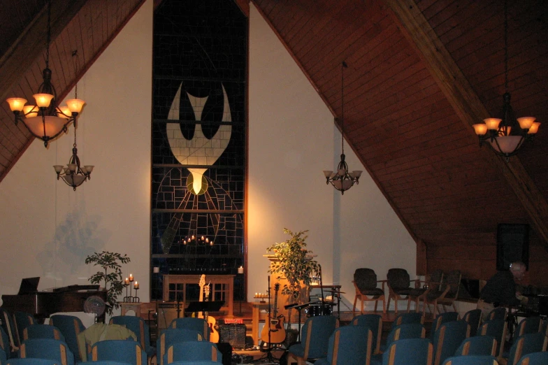 an image of a room filled with chairs and a giant clock