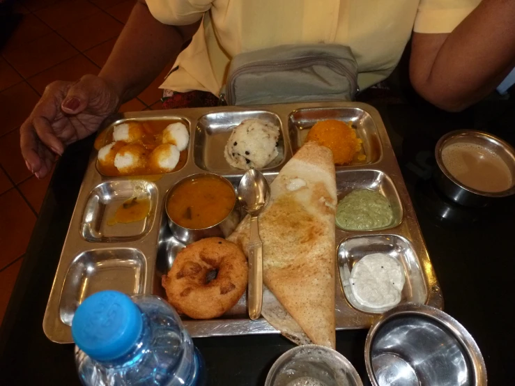 people are eating their meal from an aluminum tray