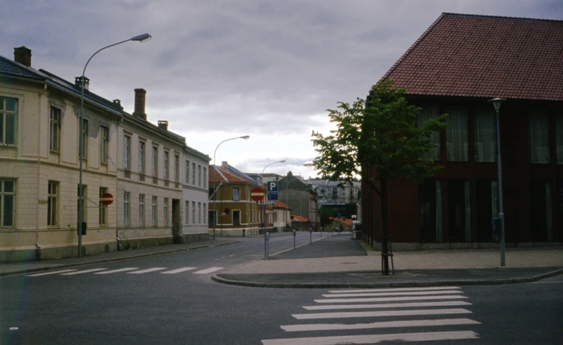 an empty street with trees and old buildings