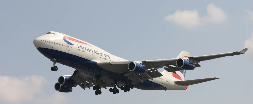 a jetliner flying through the sky with its landing gear out