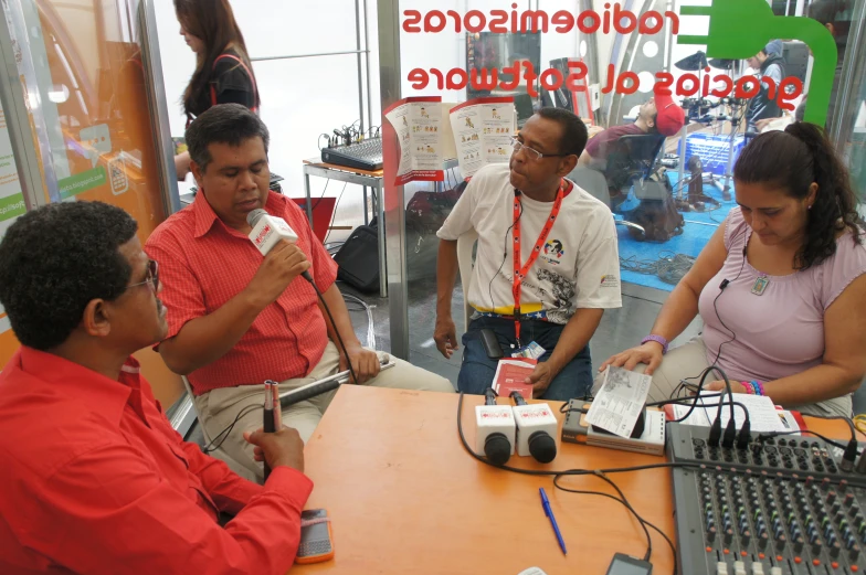 a group of people standing around a room together