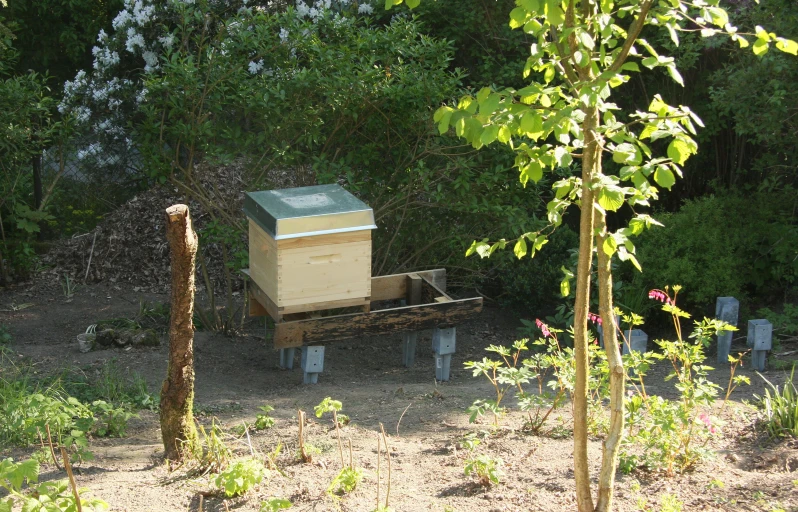 the wooden wagon is loaded with a beehive