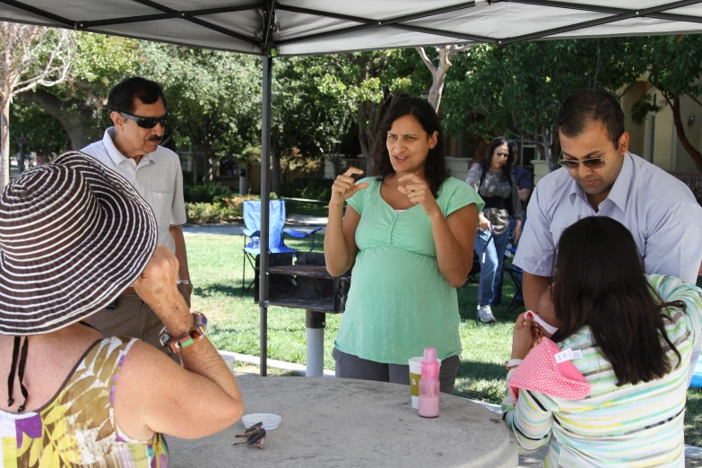 people looking at soing while a woman blows out her fingers