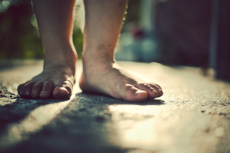 a person standing with their feet in the sand