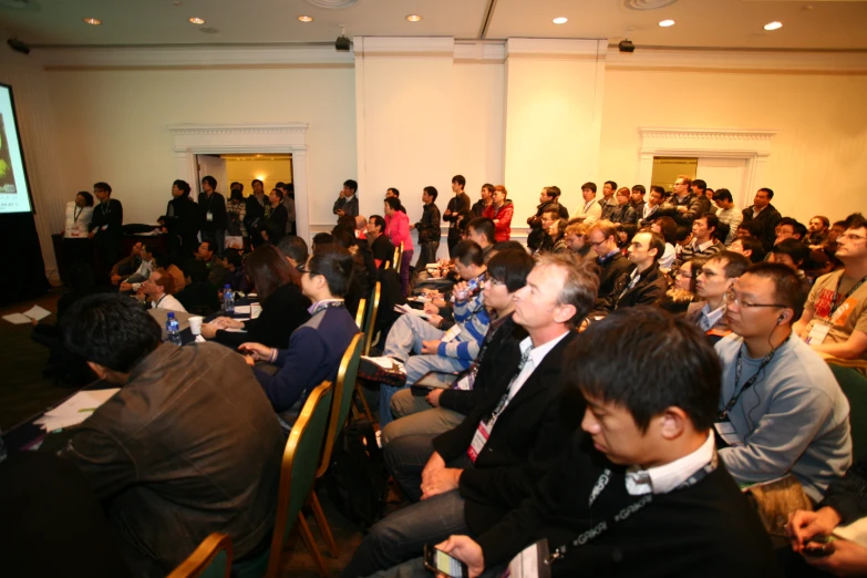 a group of people sitting on top of chairs