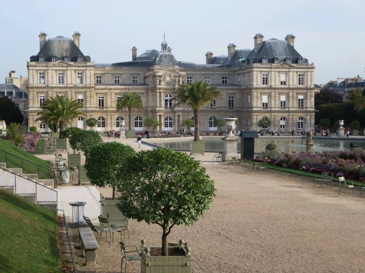 an image of a beautiful mansion surrounded by gardens