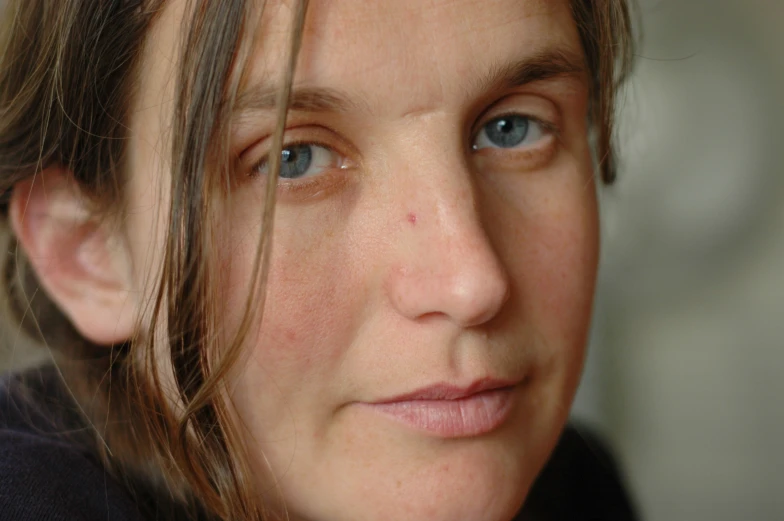 closeup of a woman with brown hair and blue eyes