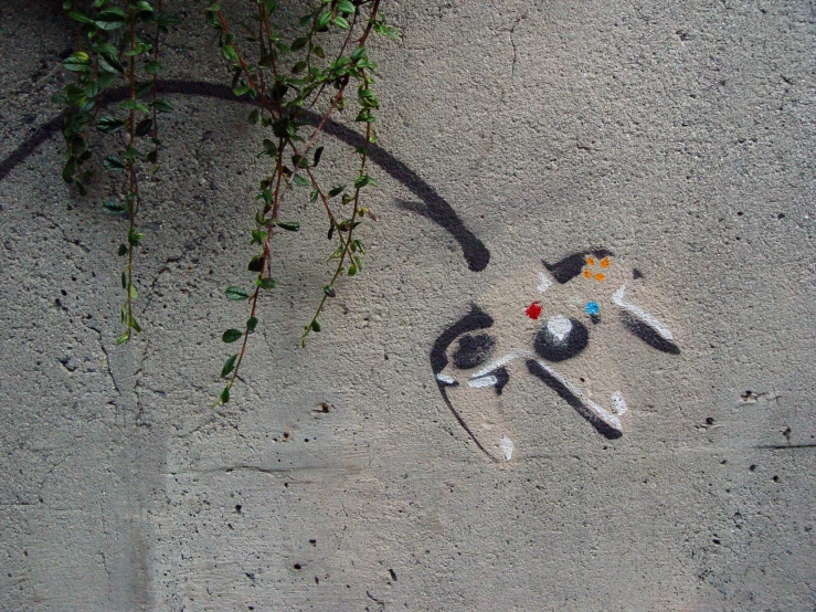 a dog on the ground painted with multicolored beads