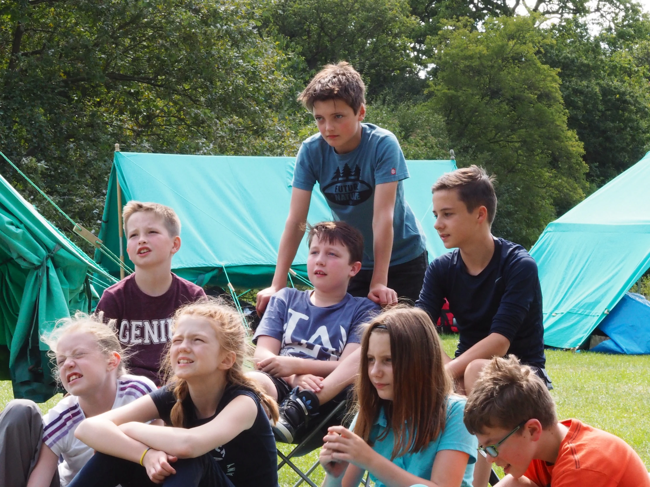 the children have stopped to take a break from playing soccer