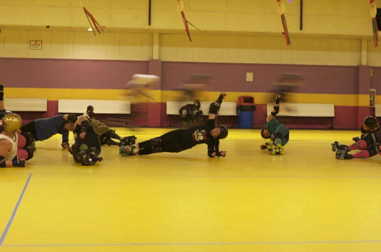 several skateboarders in a large indoor gym