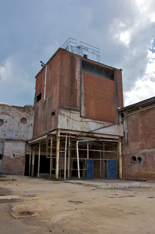 an abandoned building under construction with broken and damaged doors