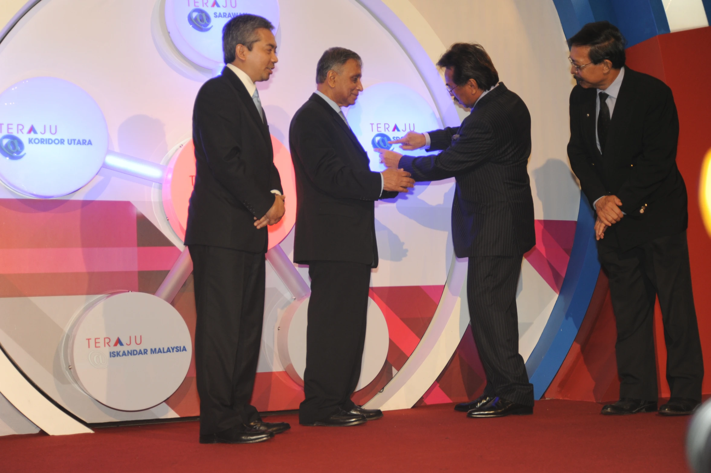 three men standing at the same time shaking hands