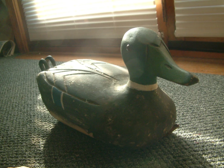 an old fashioned rubber duck sitting on the floor