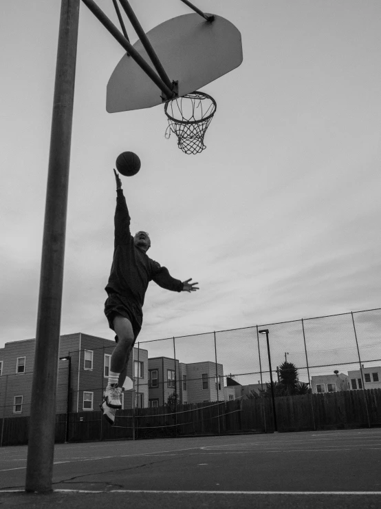 a person is jumping up to grab a ball