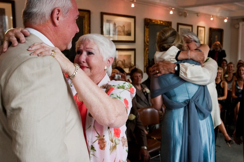 an older couple dances together at a reception