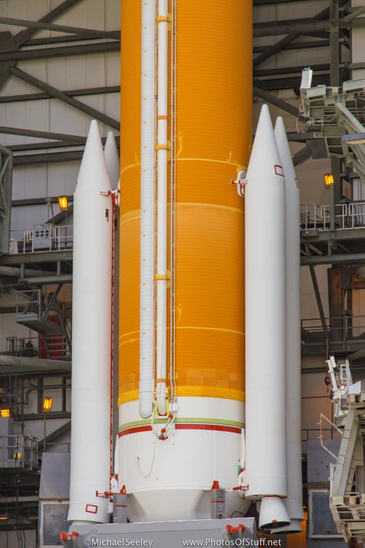 the large yellow cylinder of the rocket is next to the larger one