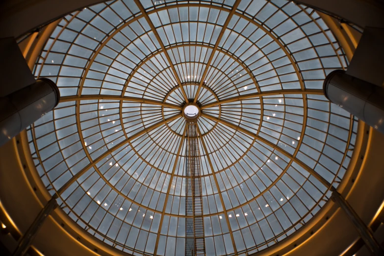 a building with a glass ceiling and various objects in it