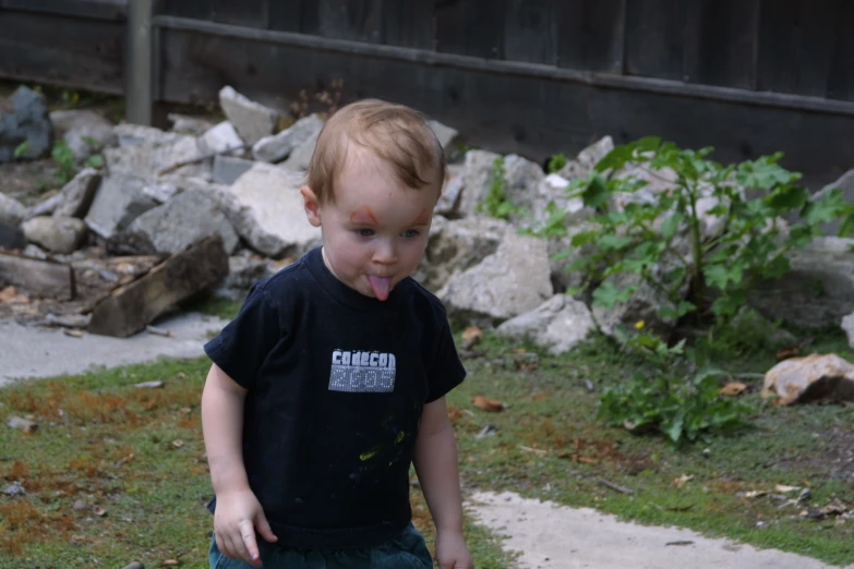 a boy with a tongue sticking out and making a silly face