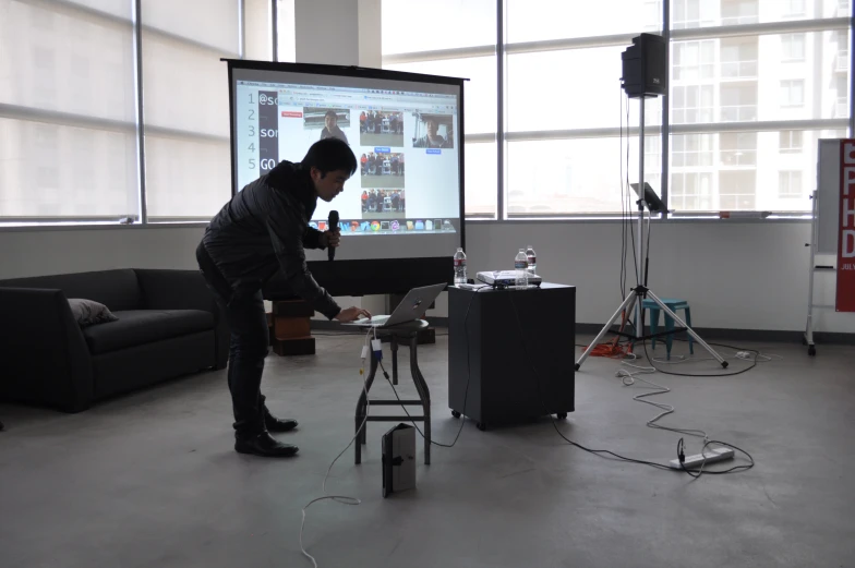 the man is repairing a laptop on a small device