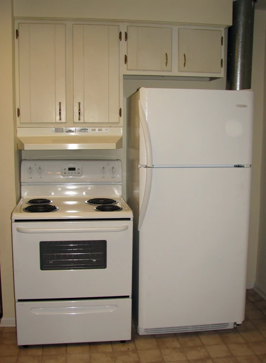 a white stove and a refrigerator in a kitchen