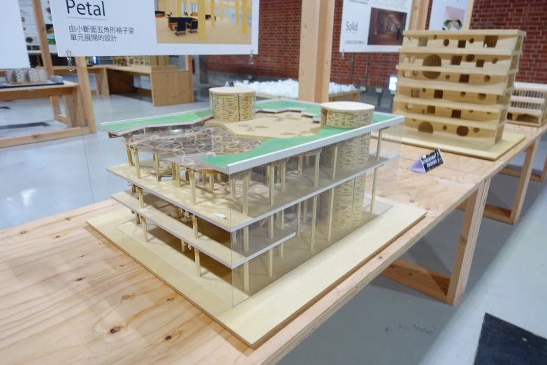 a wooden table with two model houses on it