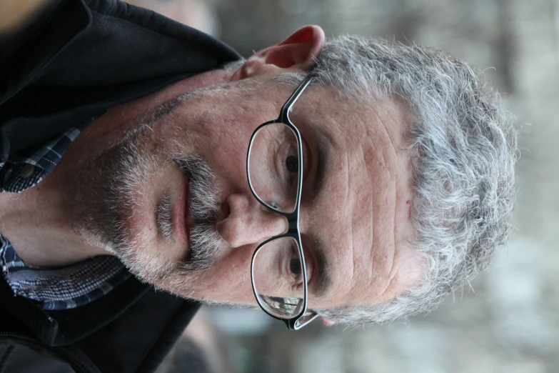 a man is walking outside in a black jacket