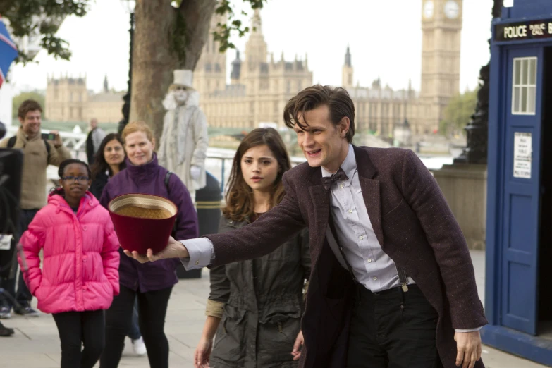 the doctor who is holding a cushion while walking with others