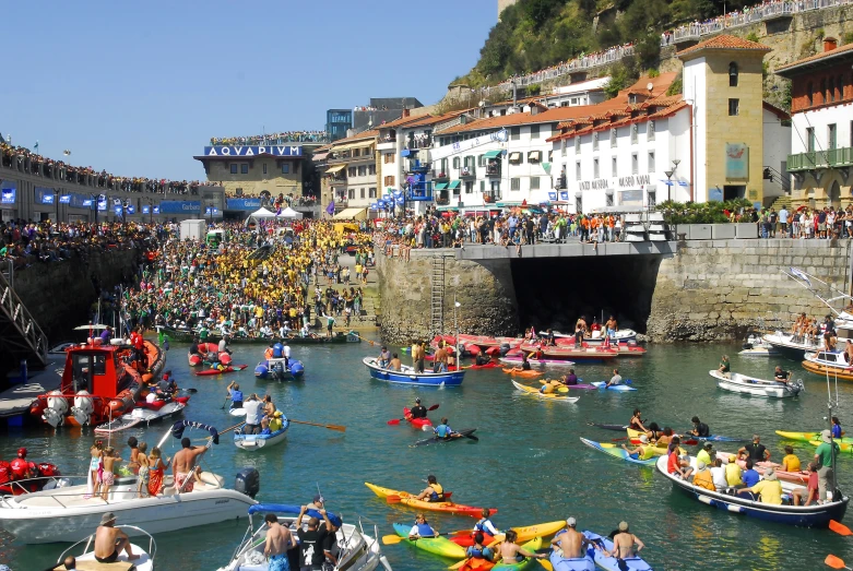 some people in boats water and some buildings