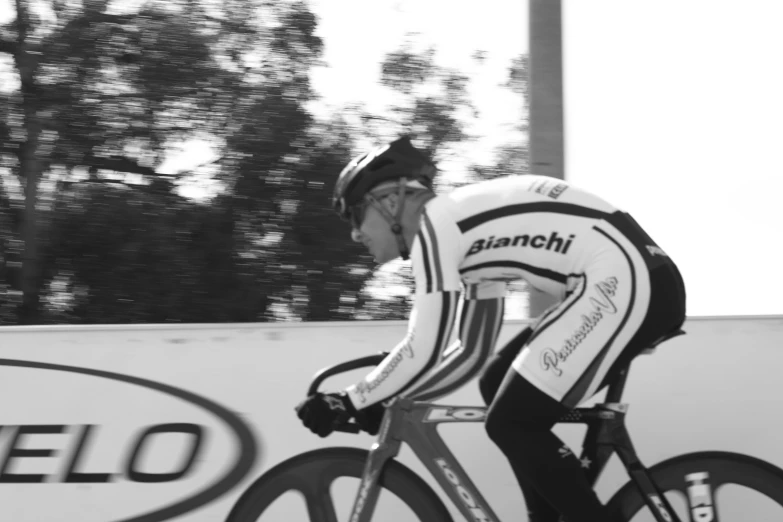 black and white pograph of a man on bicycle