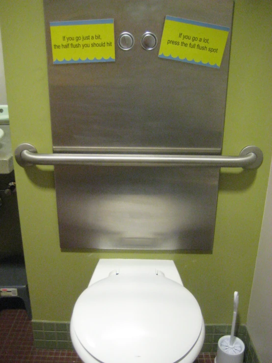a toilet with a sign on the back wall