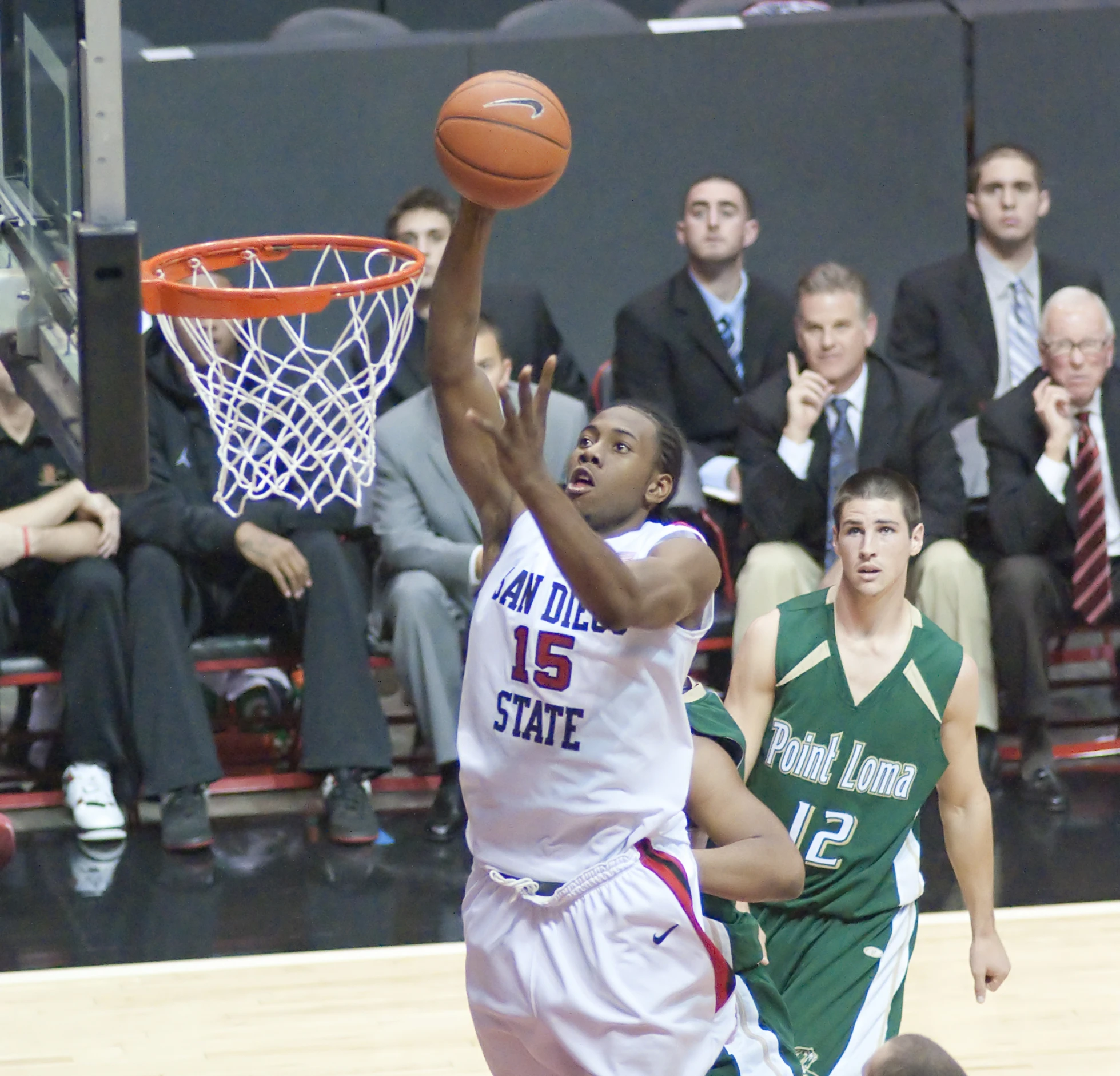 a basketball player going for the lay in a game