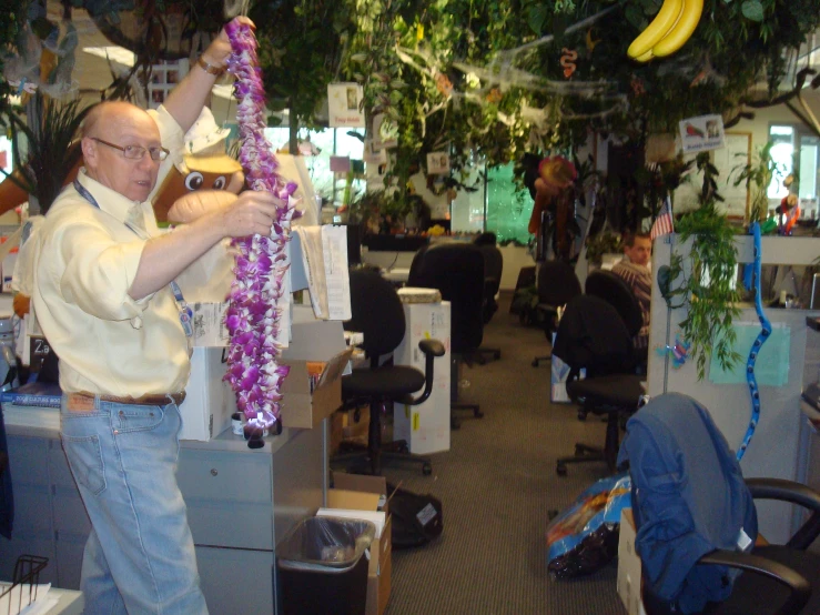 a man hanging flowers from a banana tree