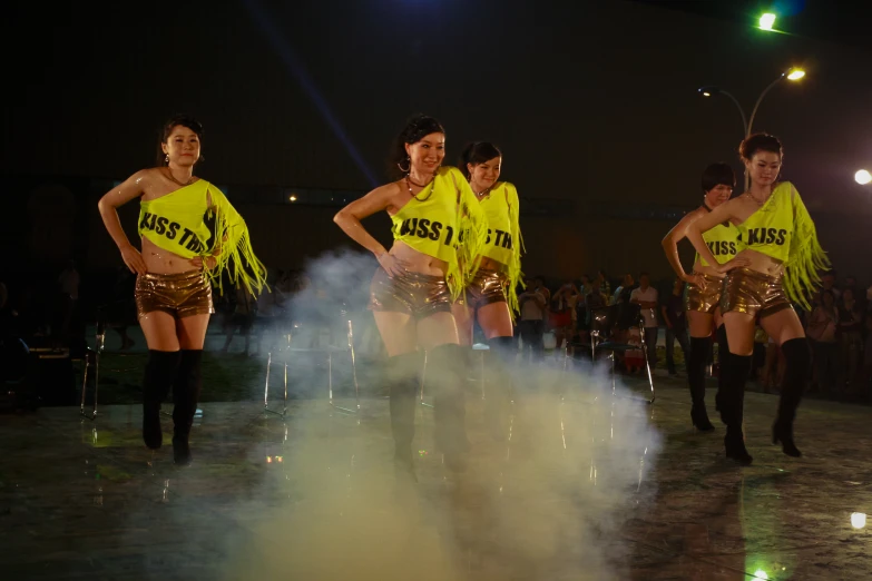 a group of dancers perform on stage at a show