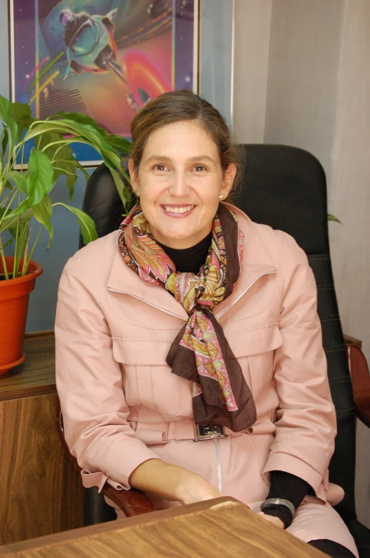 a woman sitting in a chair in front of a plant