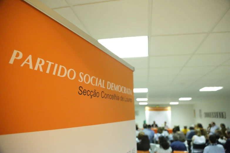 a white and orange social event board at a convention