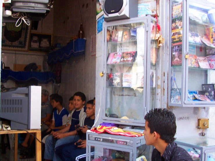 a group of people sitting and standing around a store